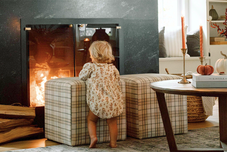 toddler in front of fireplace